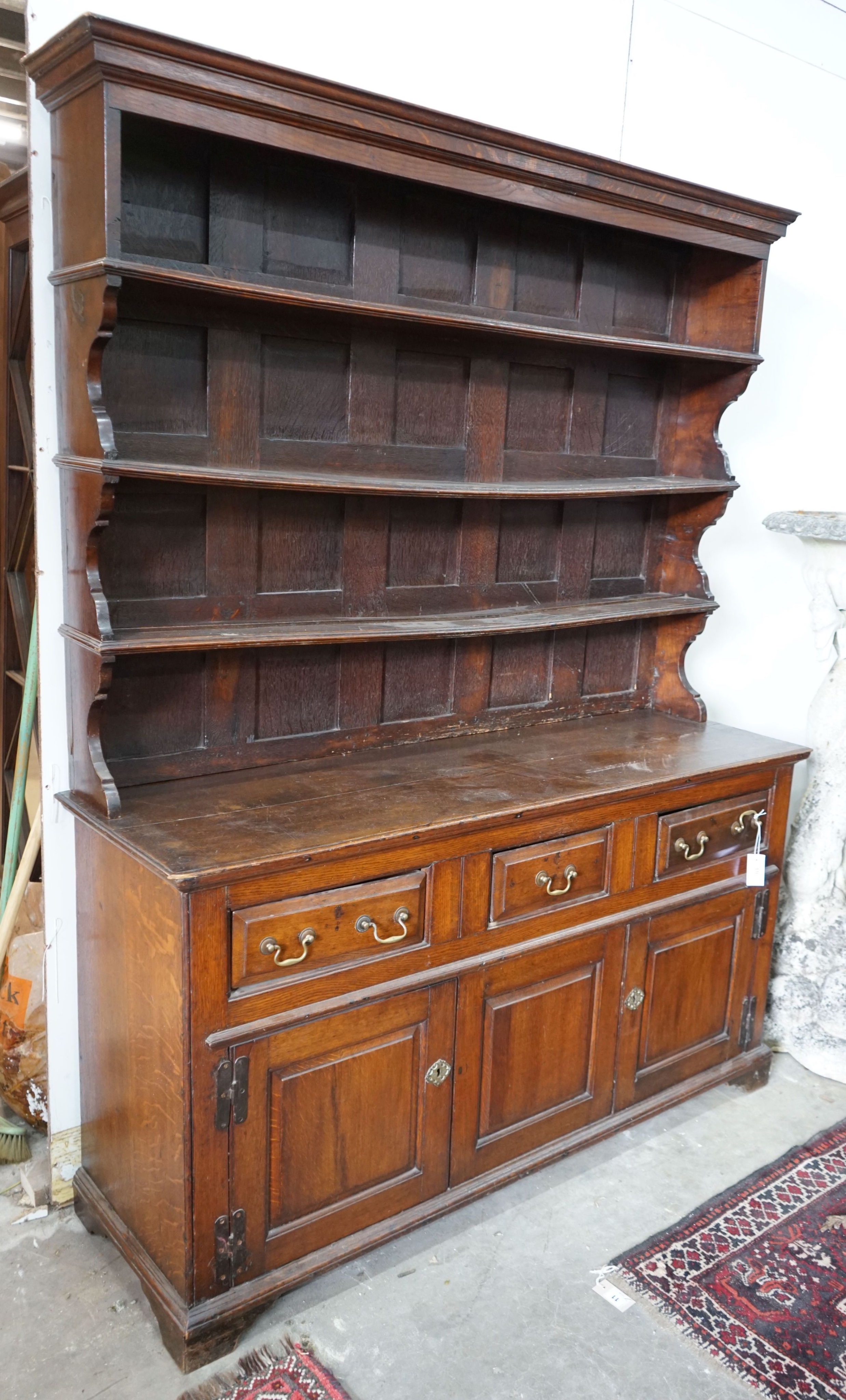 An 18th century oak dresser with boarded rack, width 150cm, depth 47cm, height 196cm